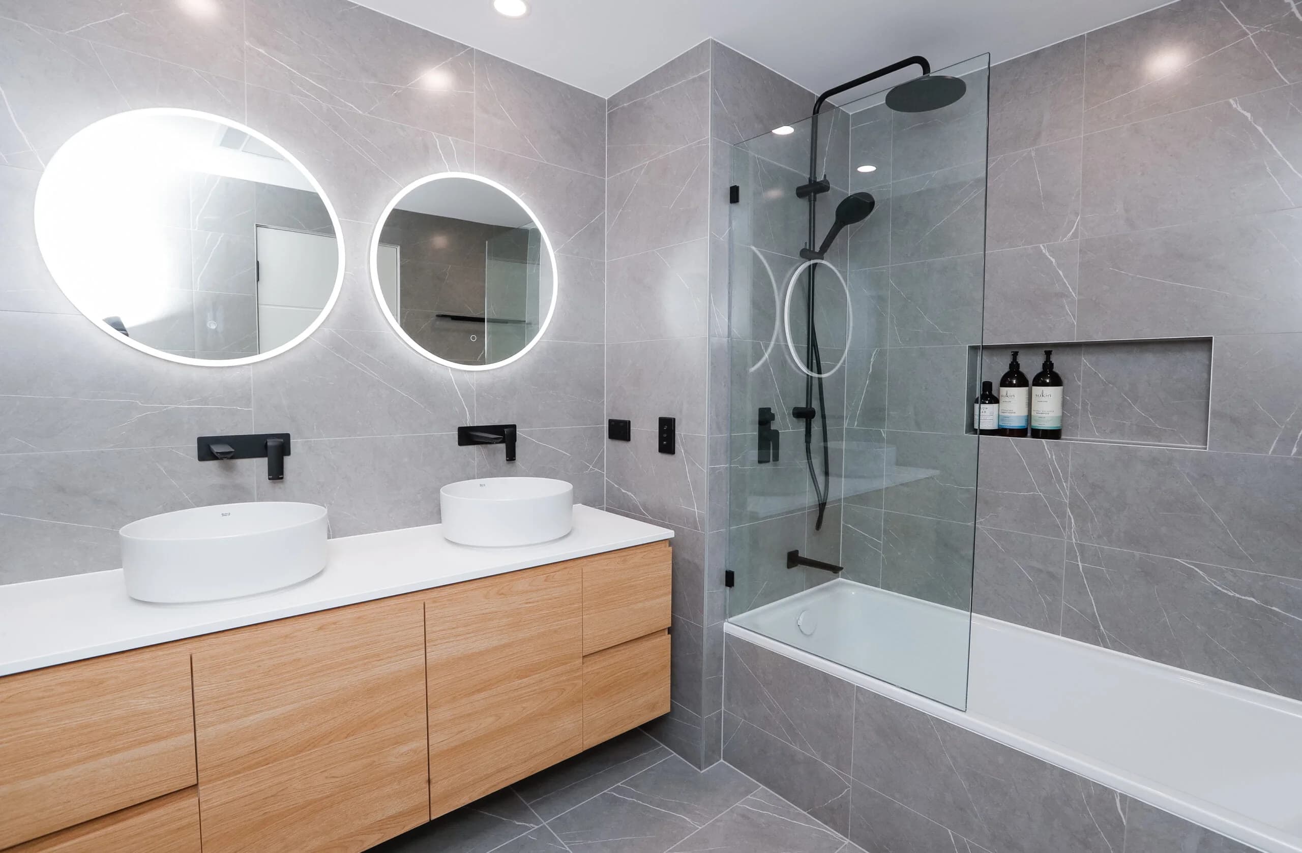 Bright bathroom makeover in Sydney with updated vanity and modern lighting